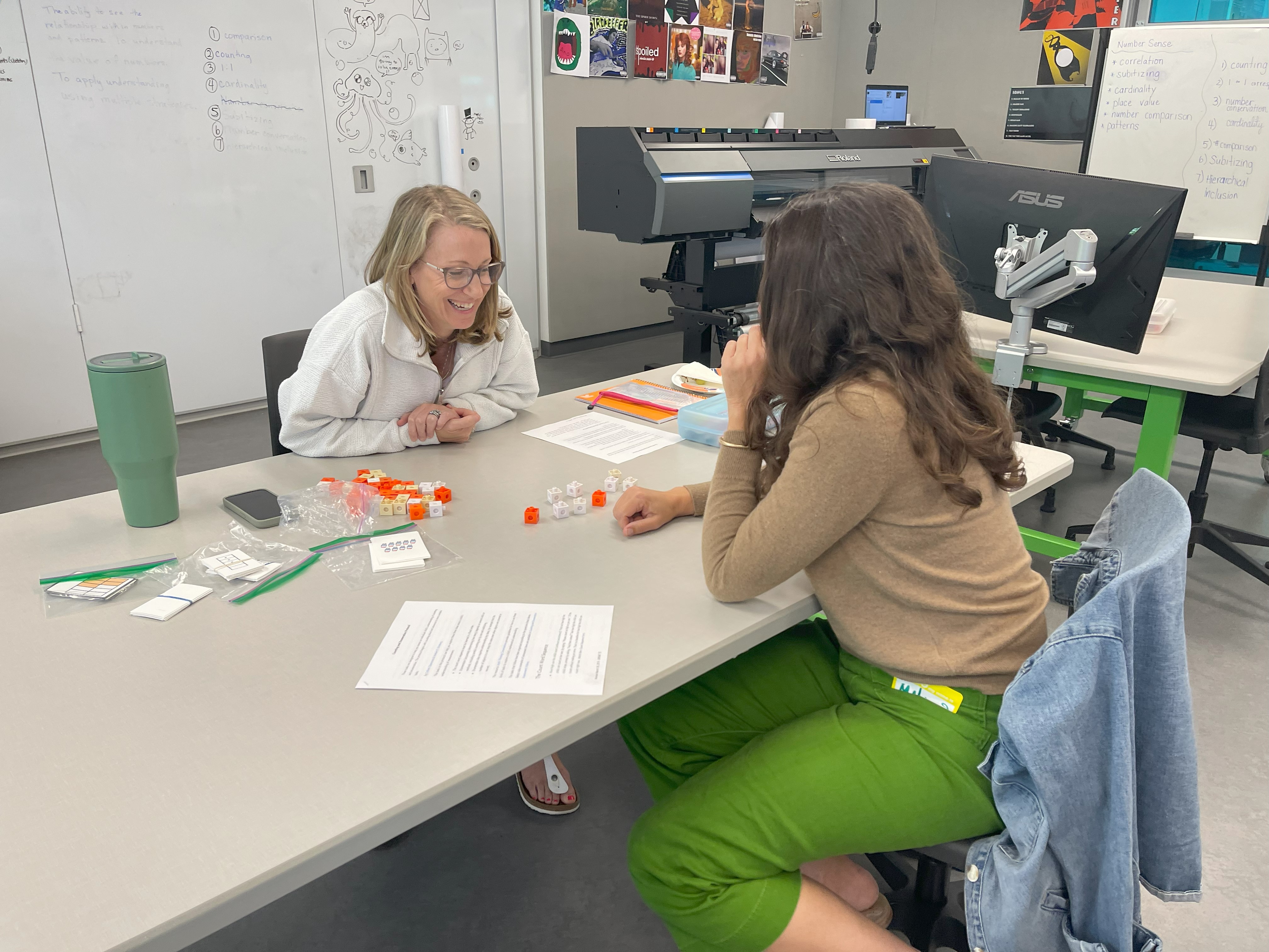 2 women at table with math manipulatives
