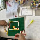 participants working with legos to solve a math problem